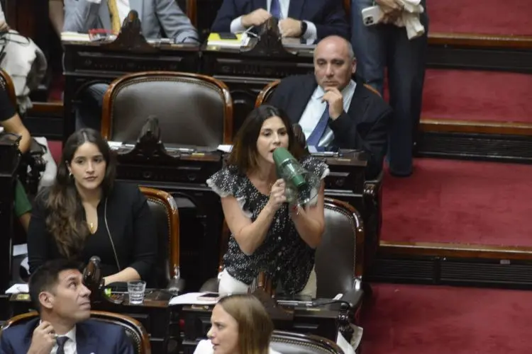 
La diputada Marcela Pagano usó un megáfono para cruzar a Menem.
